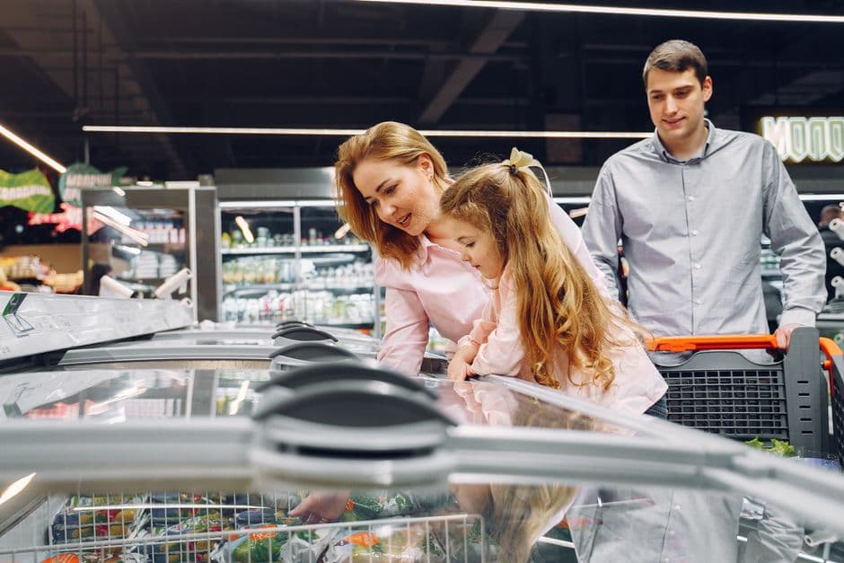 A family shopping together in a grocery aisle
