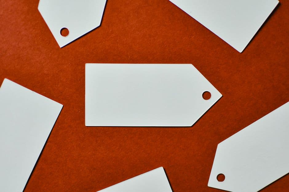 Blank white price tags on a red background