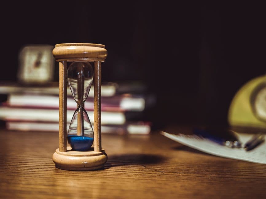 An hourglass on a wooden frame
