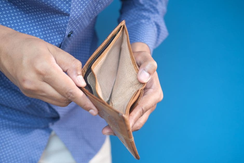 Hands holding an open, empty wallet