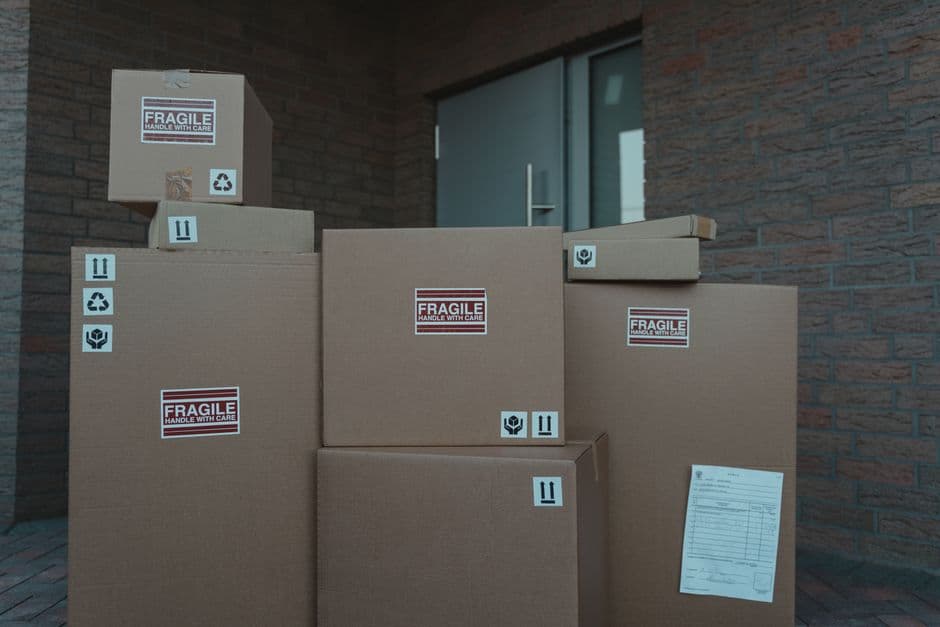 Cardboard packages stacked at a building entrance