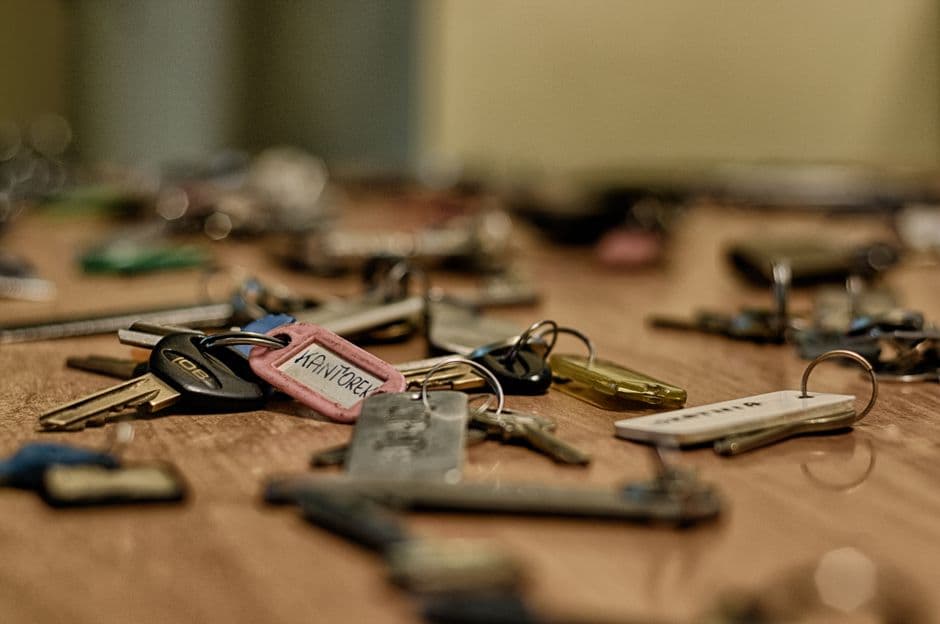 Several metal keys scattered on a wooden surface