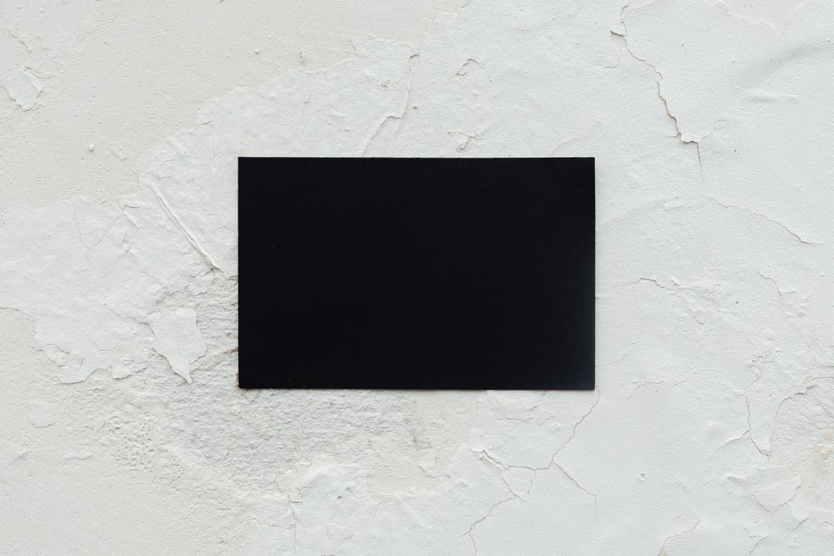 A blank card resting on a rough white textured surface