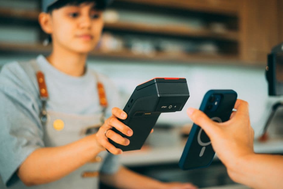 A cashier using a card terminal