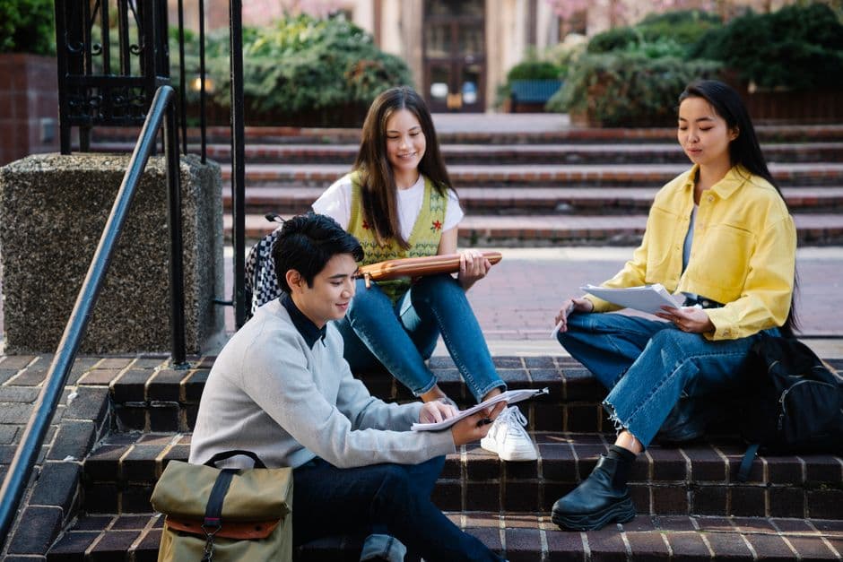 Students sitting together on brick campus steps