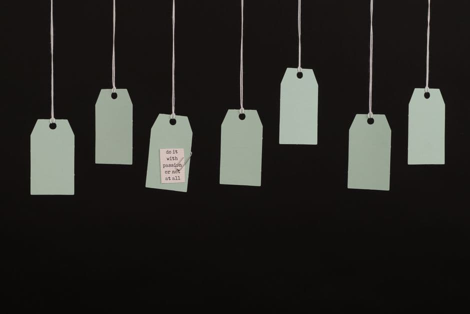 Blank paper hang tags on a dark background