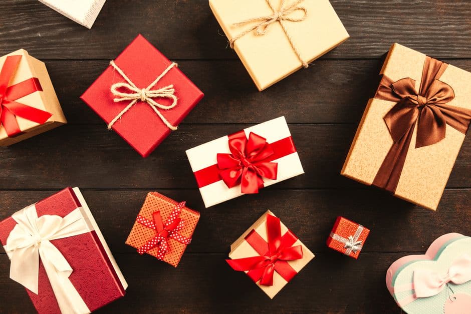 Wrapped gift boxes with ribbons on a wooden table