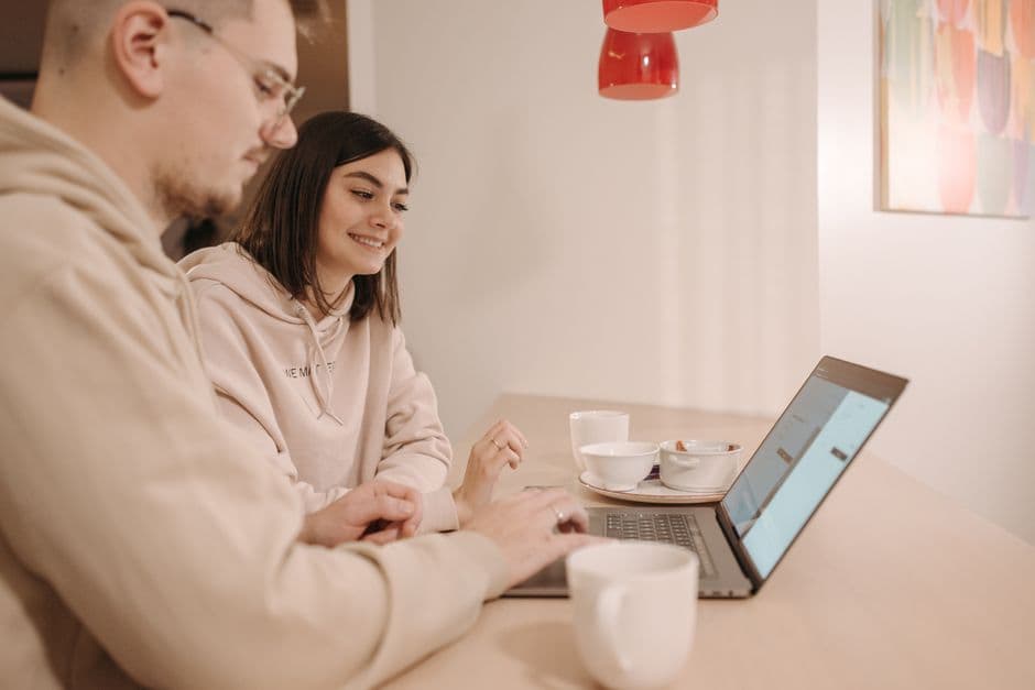 Two people looking at a laptop together