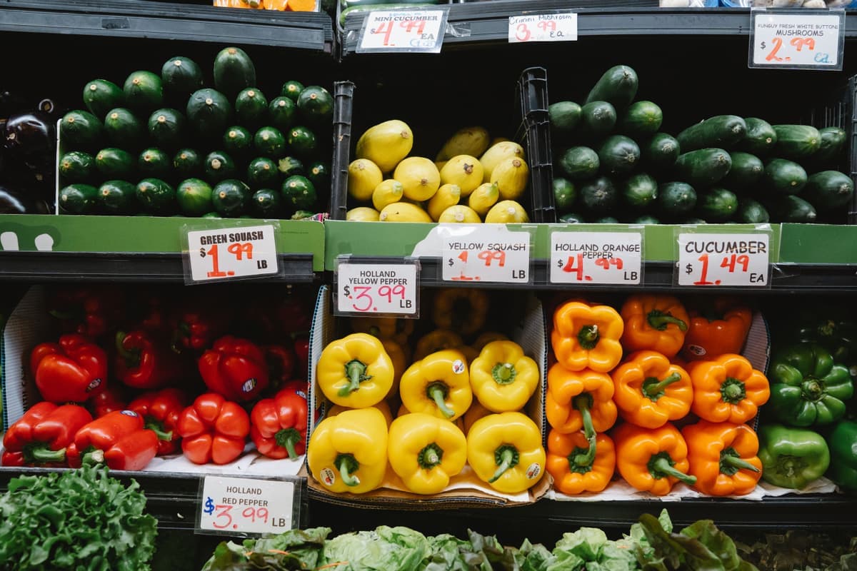 Fresh peppers and squash on a supermarket produce display