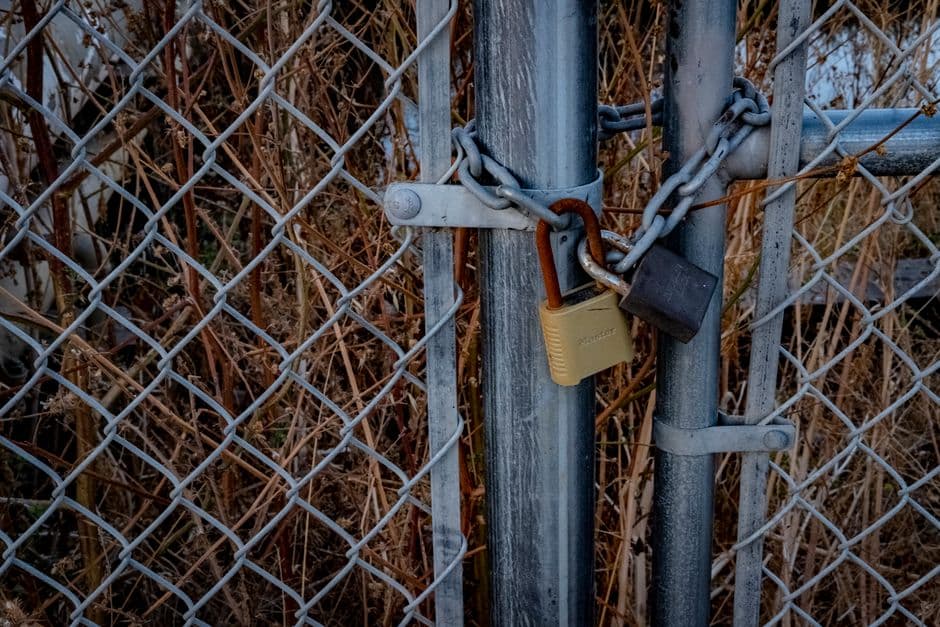 Padlocks fastened to a chain-link fence