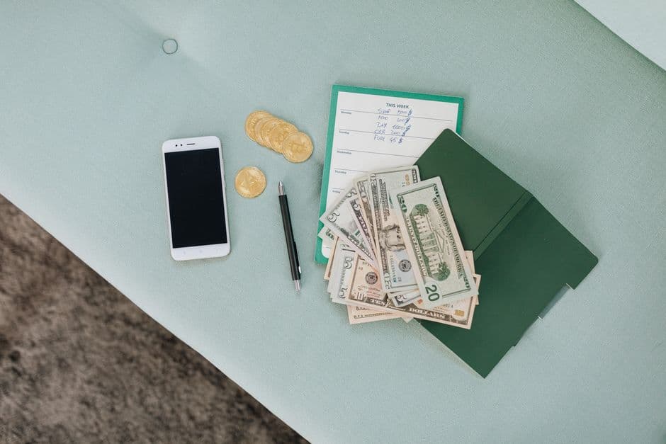 Cash, coins and a notebook on a table