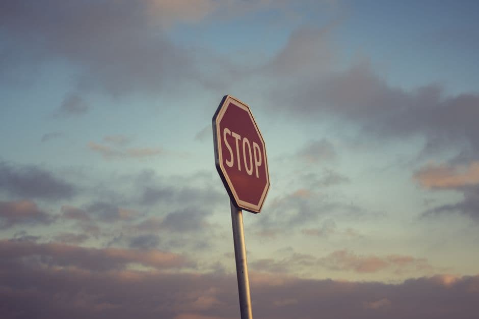 A traffic sign against a cloudy sky