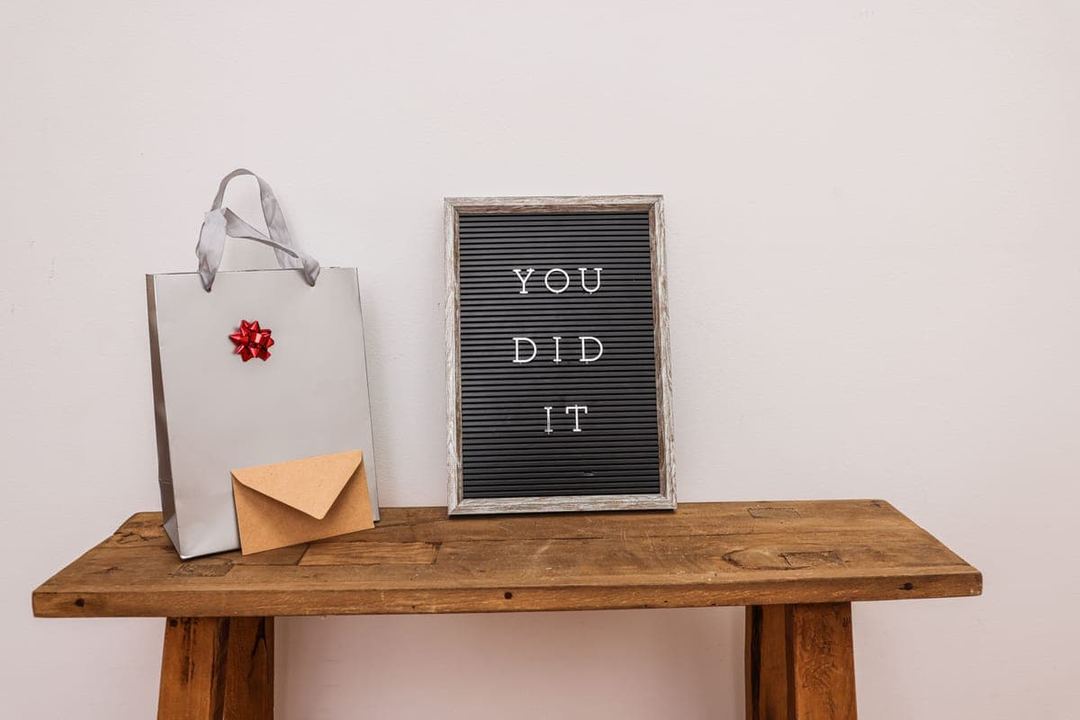 A gift bag and envelope on a wooden table