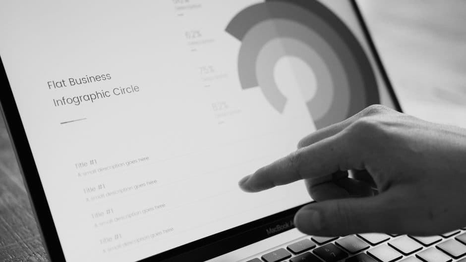 A person pointing at a laptop screen